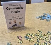 Community Puzzle at the Library. Hang out, add a piece, or more!