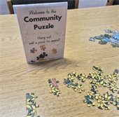 Community Puzzle at the Library. Hang out, add a piece, or more!