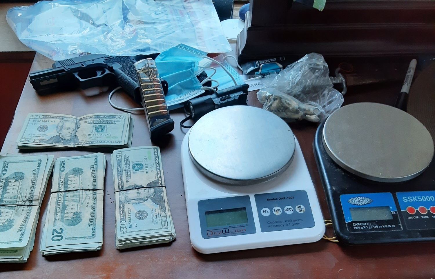 A firearm, cash and scales