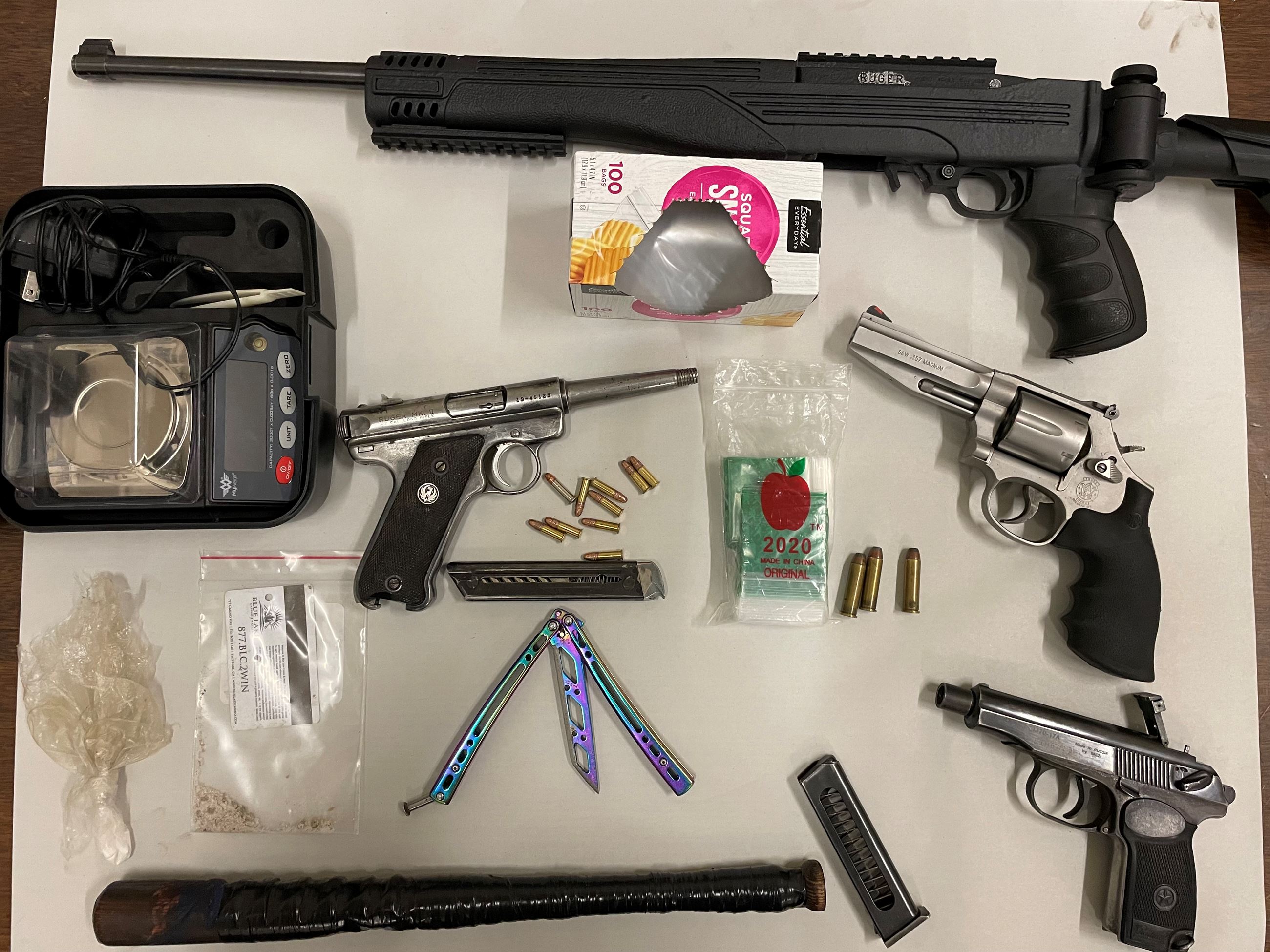 Firearms, narcotics, packaging materials seized