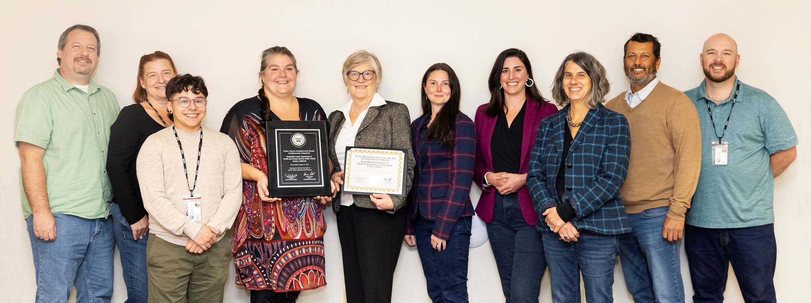 Public Health staff with their certificate and P H A B plaque 