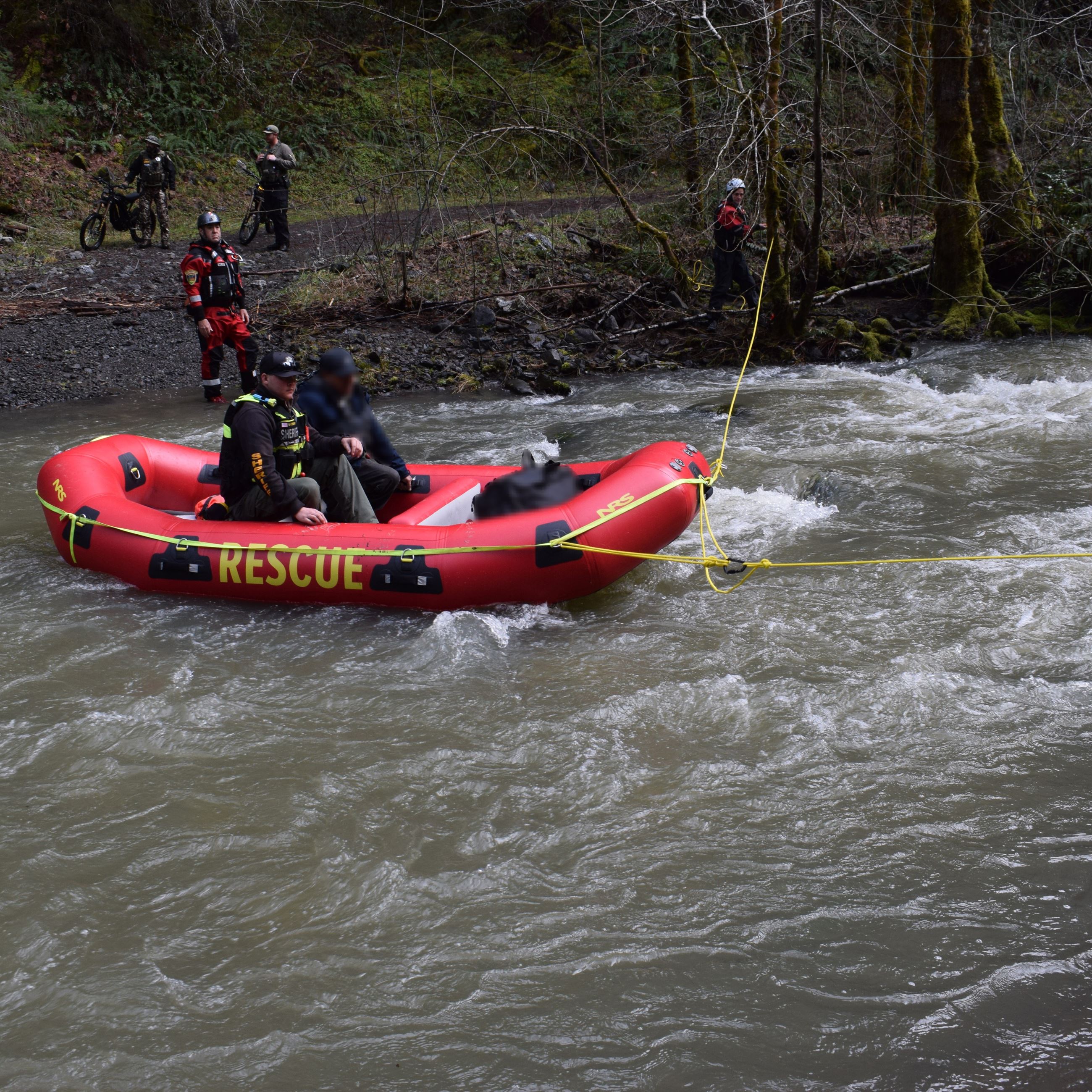 Deputy and victim raft across flooded road