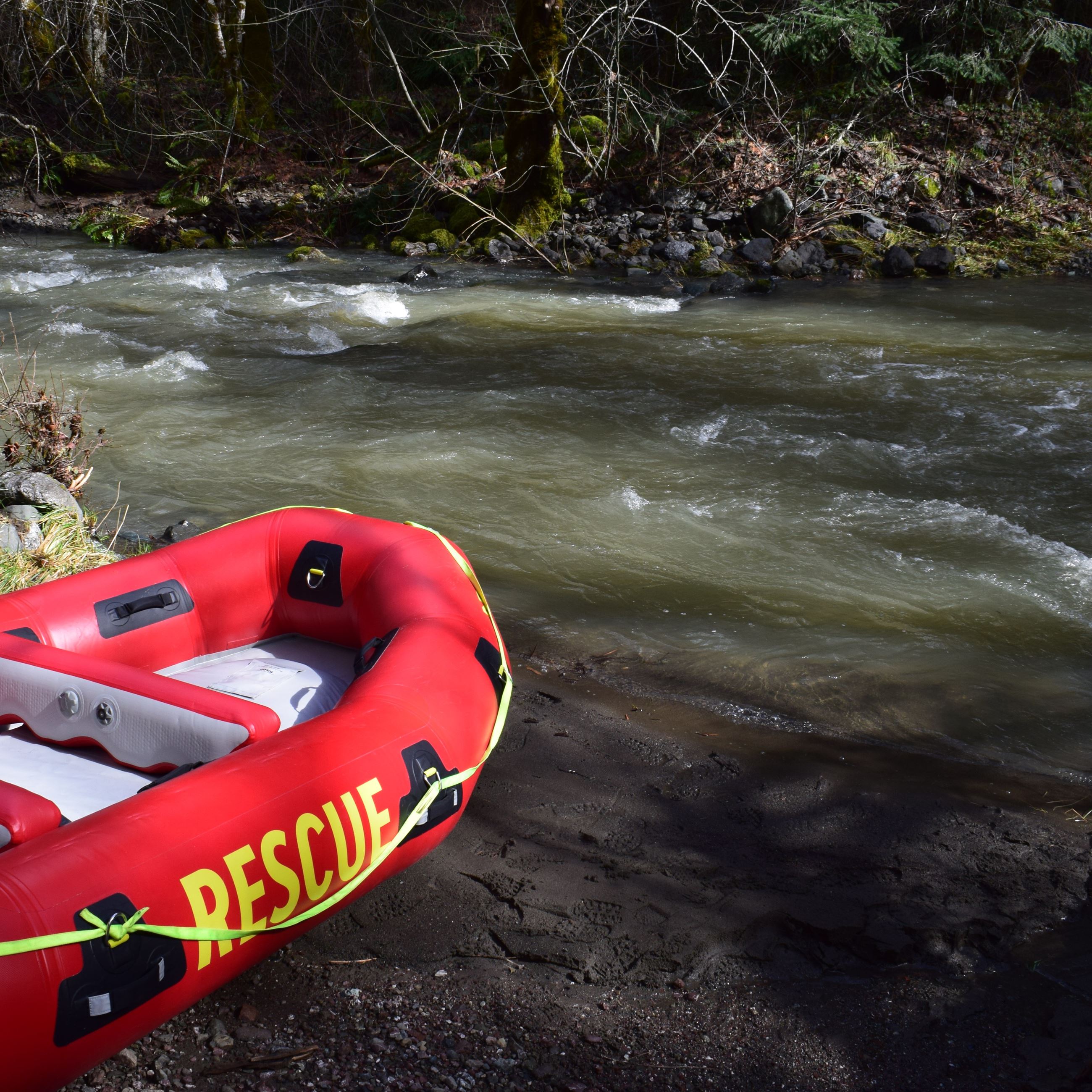 Rescue raft pulled up to flooded road 