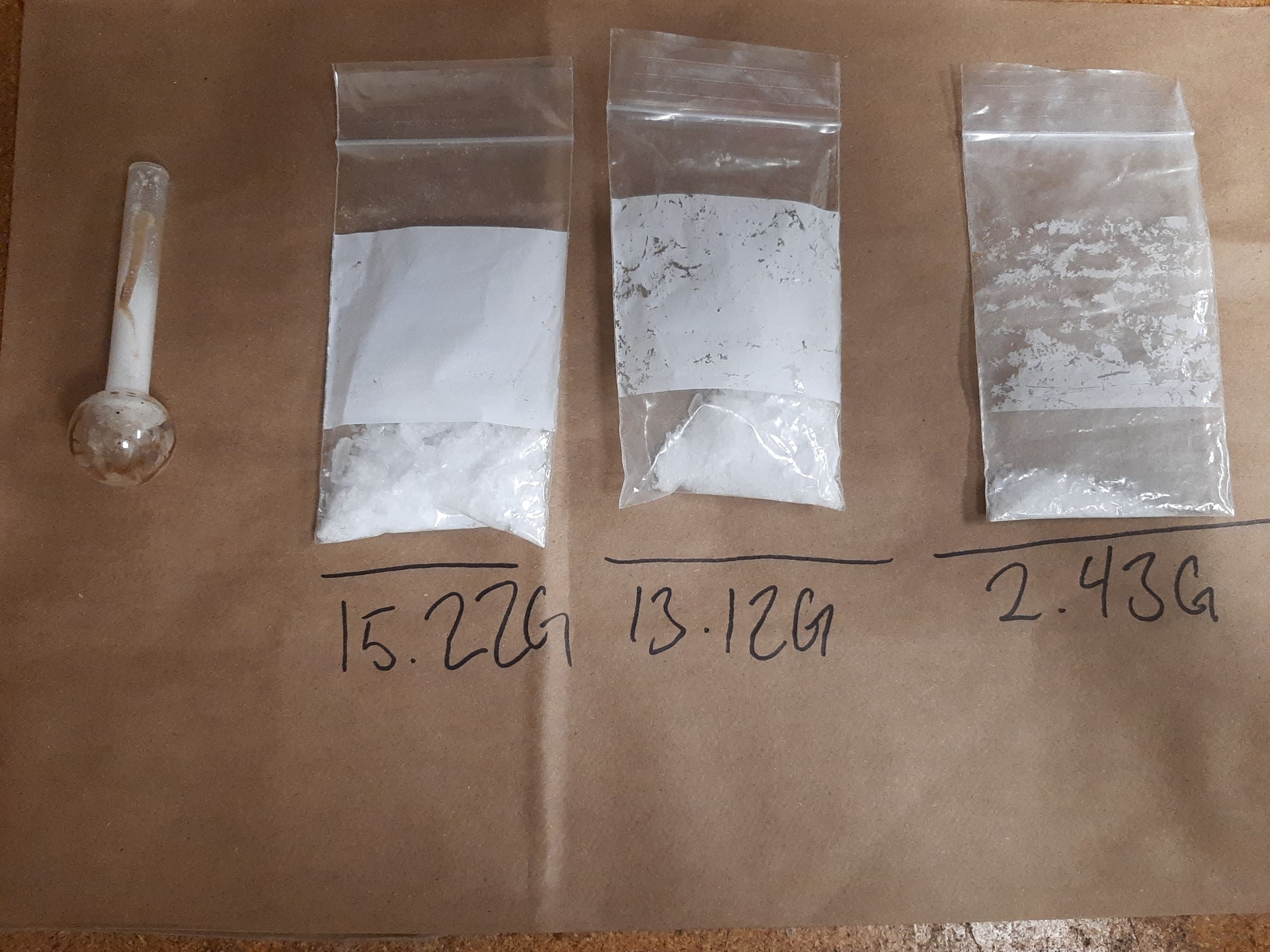 Evidence photo showing 3 bags of methamphetamine and glass pipe