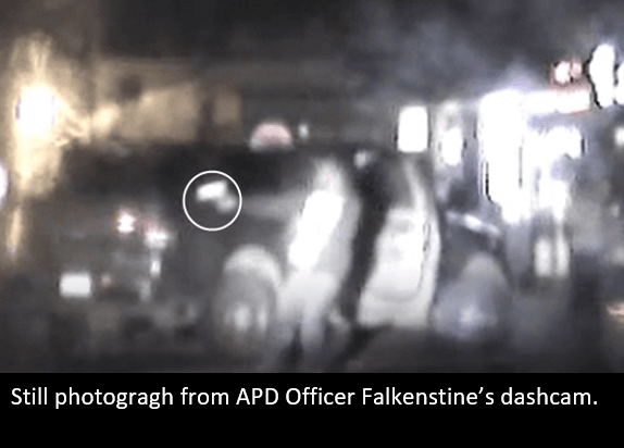 Dashcam photo showing person aiming gun.