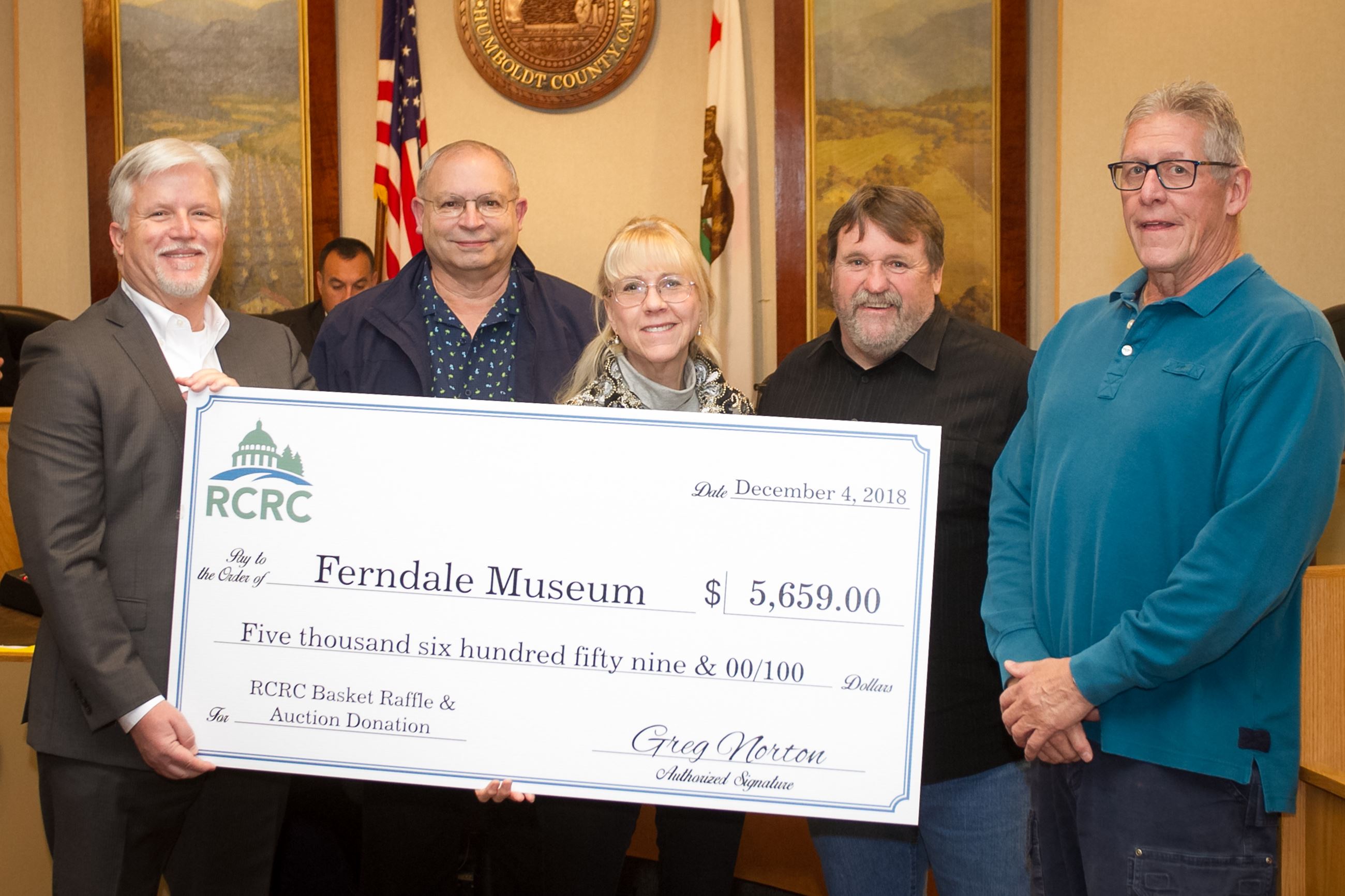 Supervisor Rex Bohn, second from right, and RCRC Chief Executive Officer Greg Norton, left, present 