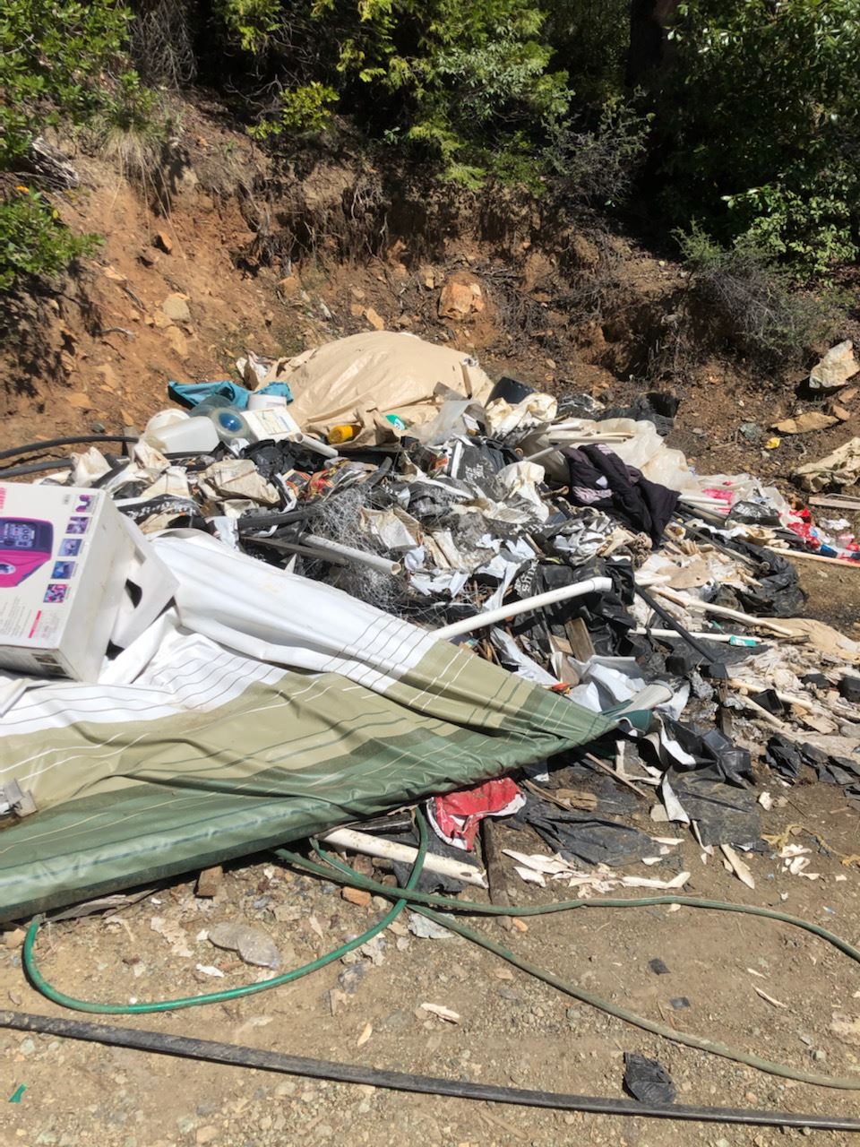 Pile of trash found on a rural property 