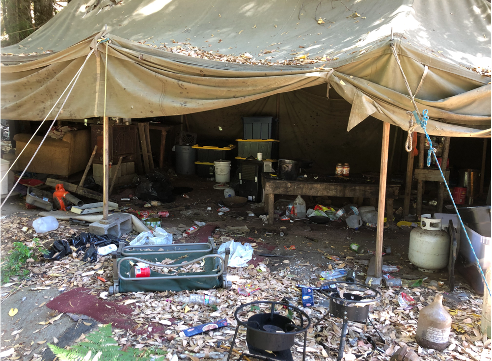 Cooking shack and garbage spread about.